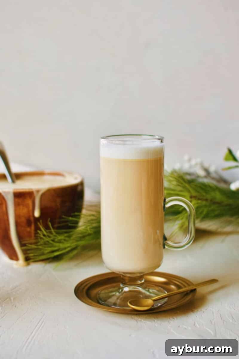 Hot buttered rum on a plate with a spoon, inviting warmth.