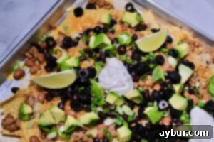 Perfect Movie Night Sheet Pan Nachos 1 A beautifully arranged plate of loaded nachos, fresh and vibrant