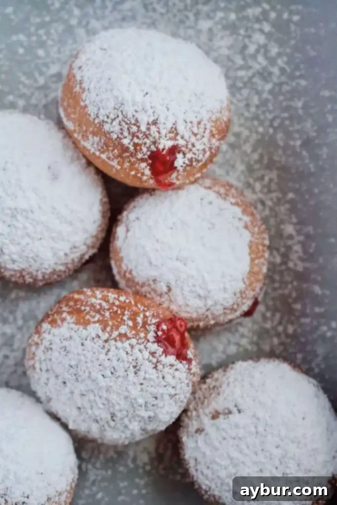 Polish Paczki Jelly Donuts - A close-up of fluffy, sugar-dusted paczki