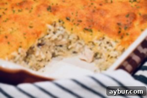 The Quintessential Comfort Casserole 3 A serving of the casserole dished onto a plate, showcasing its golden crust and creamy interior, ready to be enjoyed.