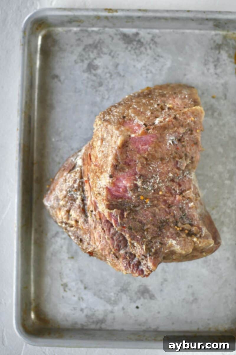 A cooked corned beef brisket, just removed from the Instant Pot, showing its tender texture before glazing.