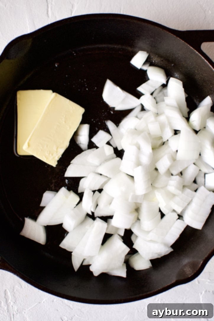 Onions and butter in a cast-iron pan.