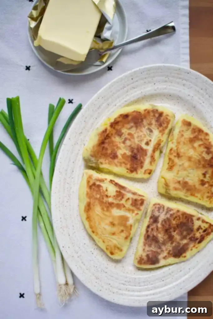 Stack of Irish potato bread farls with melted butter.