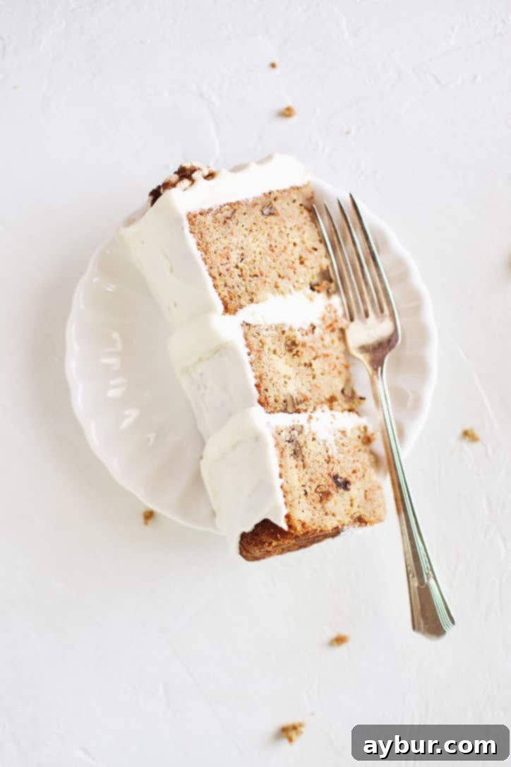 Carrot Cake with Pineapple and Orange, topped with cream cheese frosting and candied walnuts.