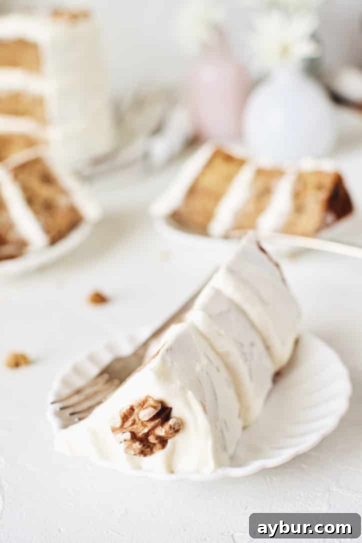 A slice of Carrot Cake with Pineapple and Orange, showcasing its moist texture and rich frosting.