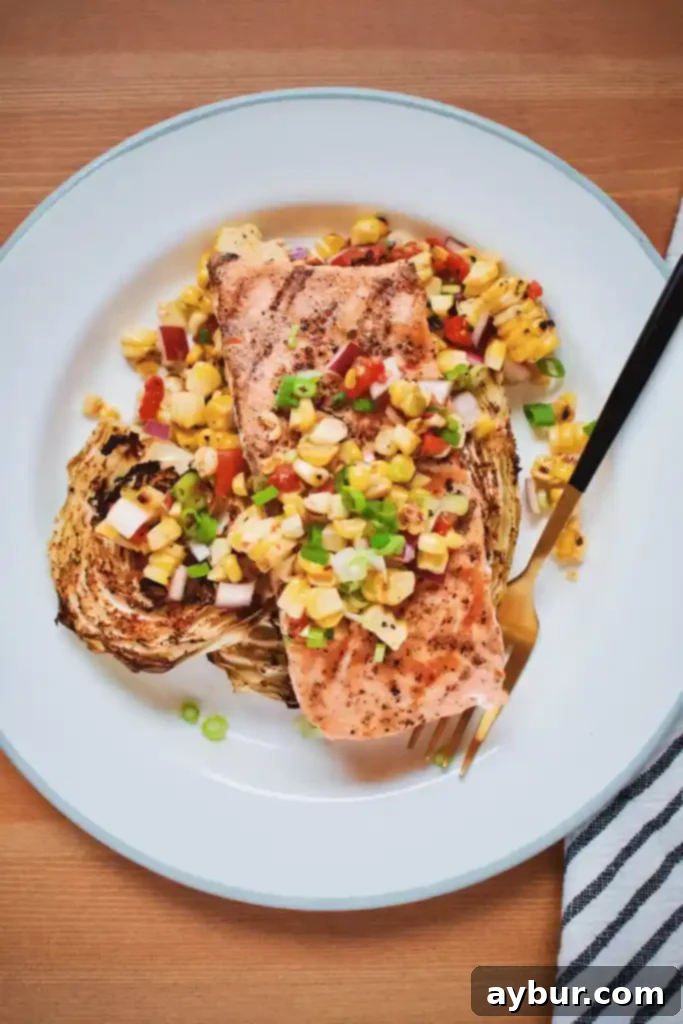 Flaky Seared Salmon with Tender Roasted Cabbage and Sweet Corn Salad 2 Seared Salmon, Roasted Cabbage and Corn Salad plated beautifully with vibrant colors