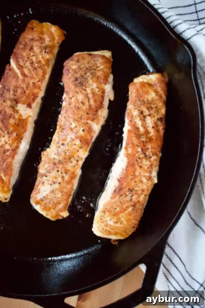 Flaky Seared Salmon with Tender Roasted Cabbage and Sweet Corn Salad 3 Close-up of a perfectly seared Atlantic Salmon fillet with crispy skin