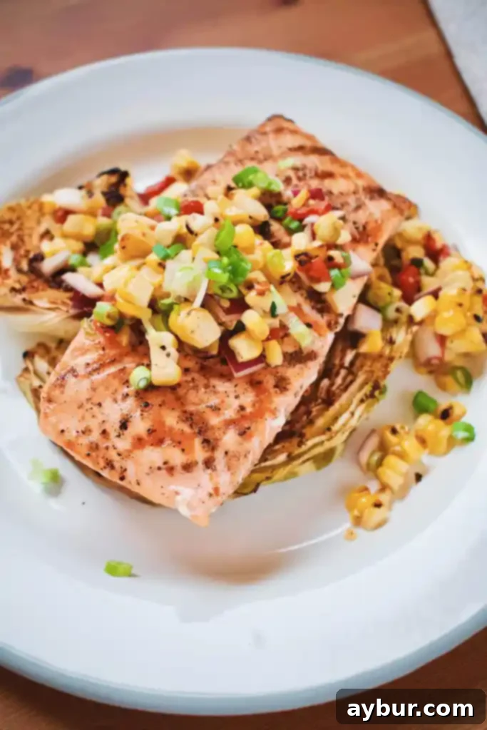 Flaky Seared Salmon with Tender Roasted Cabbage and Sweet Corn Salad 8 Seared Salmon, Roasted Cabbage and Corn Salad plated beautifully on a white dish