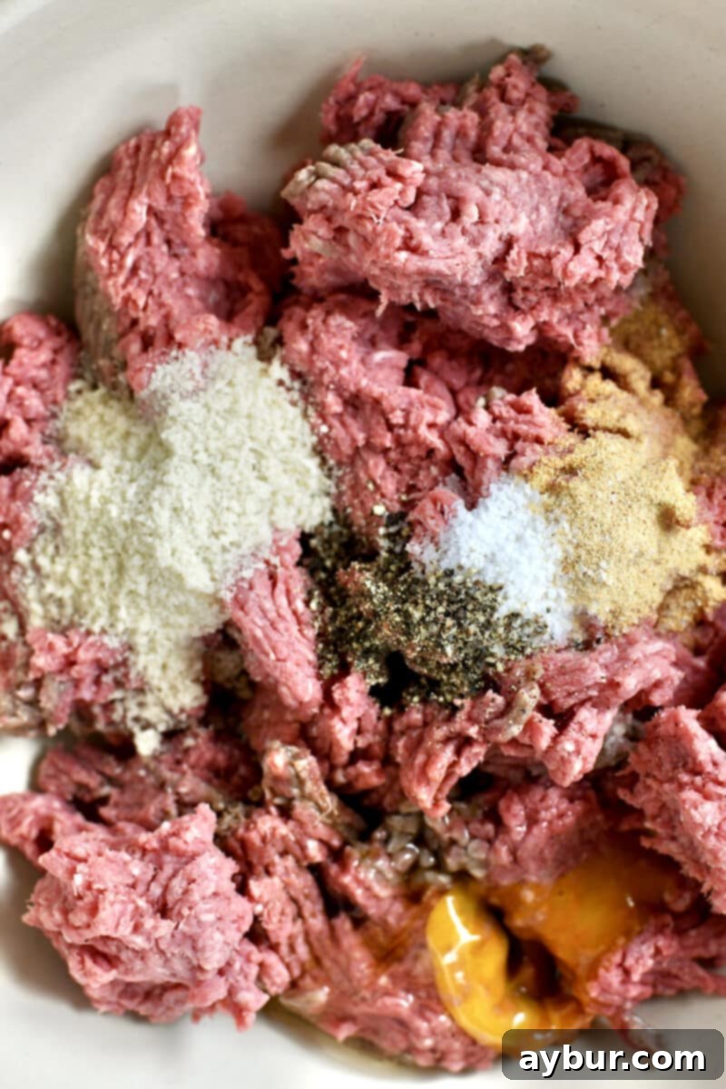 Mixing together the ingredients to make Not-So "Basic" Burgers in a large bowl.