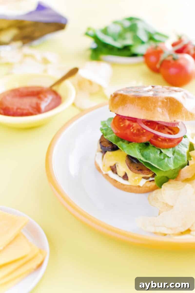 Not-So "Basic" Burger stacked up on a plate with chips and my favorite toppings.