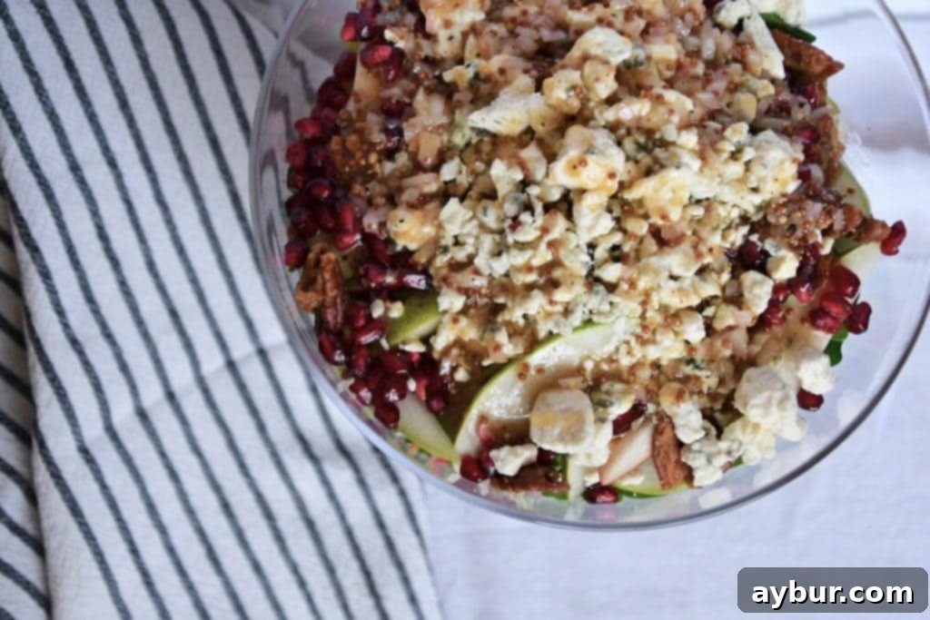 Festive Layered Arugula Salad with Pear Vinaigrette 3 Fresh pomegranate arils ready for Joanna Gaines' Layered Arugula Salad