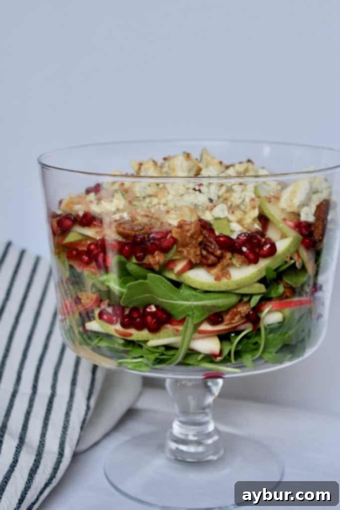 A close-up of the layered arugula salad, showing its vibrant colors and textures