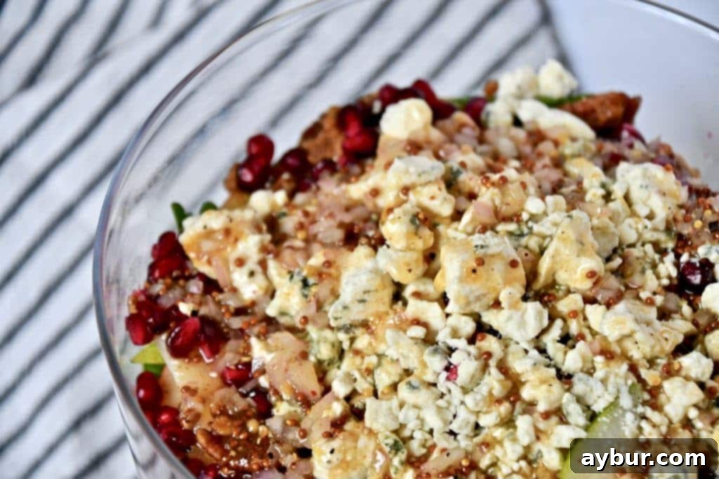 Festive Layered Arugula Salad with Pear Vinaigrette 5 Close-up of Joanna Gaines' Layered Arugula Salad, highlighting fresh ingredients and dressing