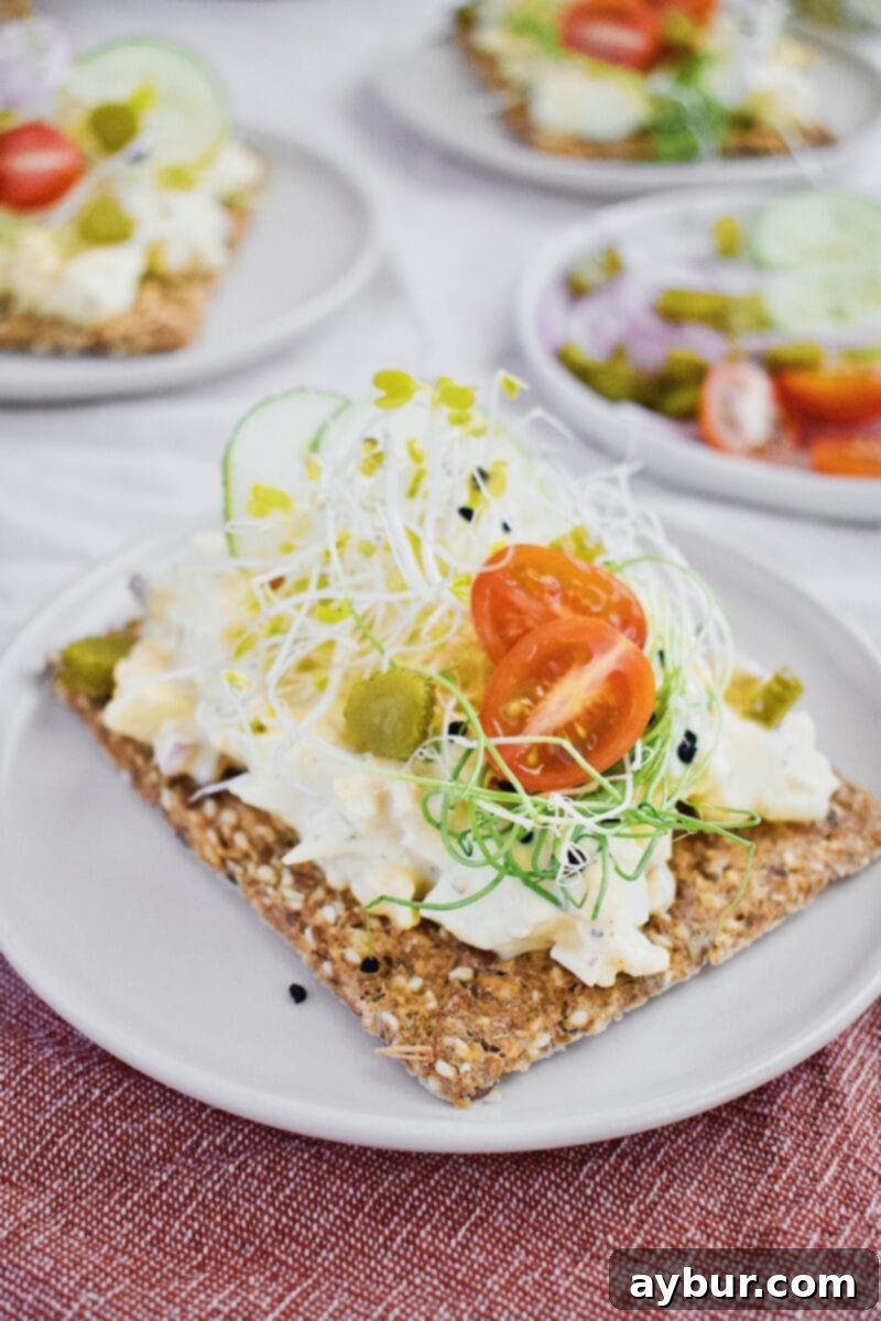 Scandinavian Dill Egg Salad 9 Nordic Egg Salad served on toast with fresh toppings, ready to eat.