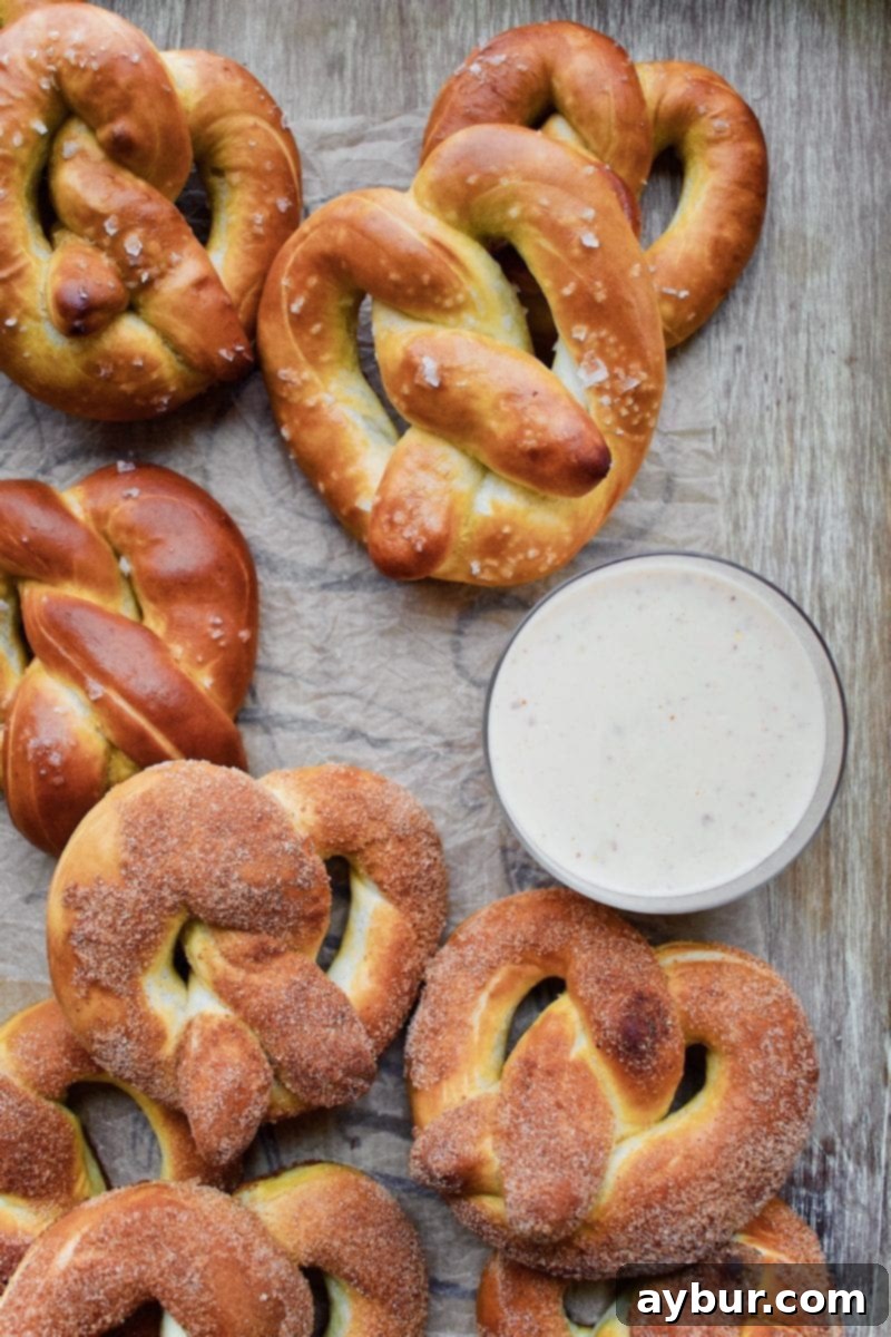 Authentic Movie Theater Pretzels and Cheese Dip 5 An assortment of Joanna Gaines' homemade pretzels, featuring both classic salted and sweet cinnamon sugar varieties on a baking sheet, ready to be enjoyed.