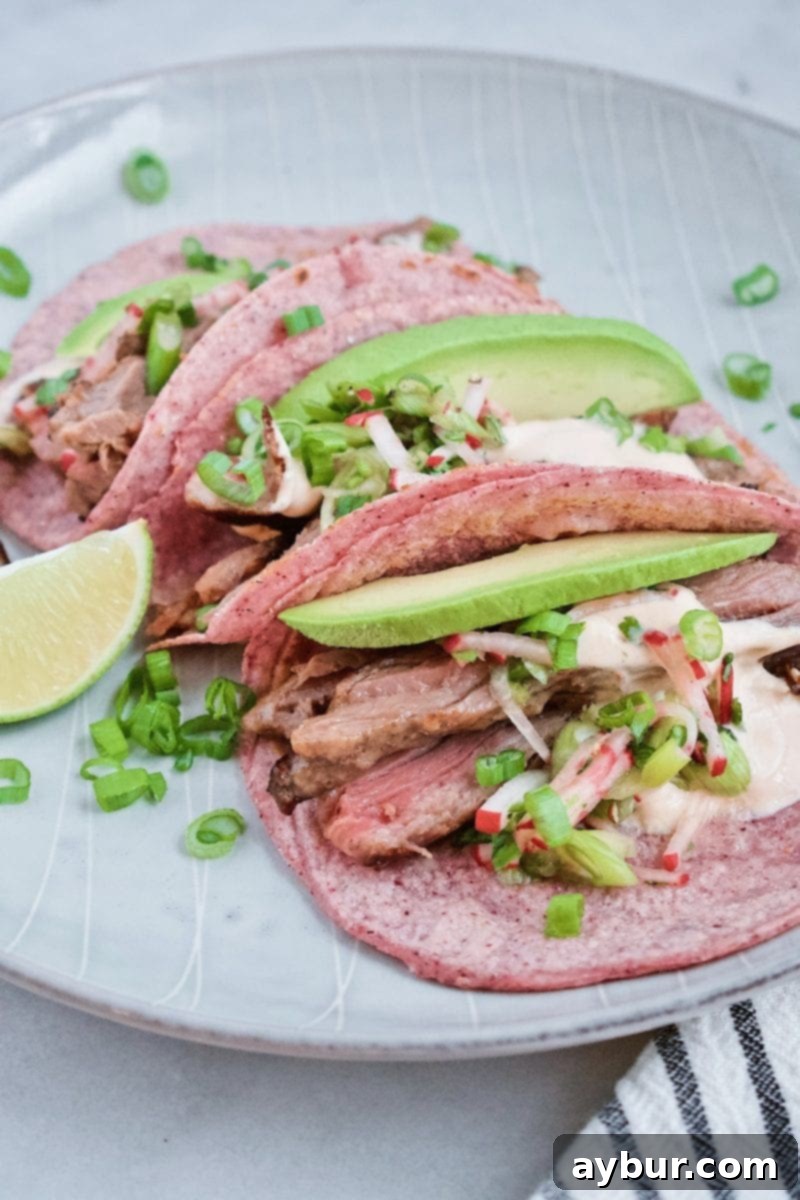 Joanna Gaines Steak Tacos with homemade blue corn tortillas, served with fresh radish salad, a dollop of crema, and a side of vibrant Cilantro Lime Rice.