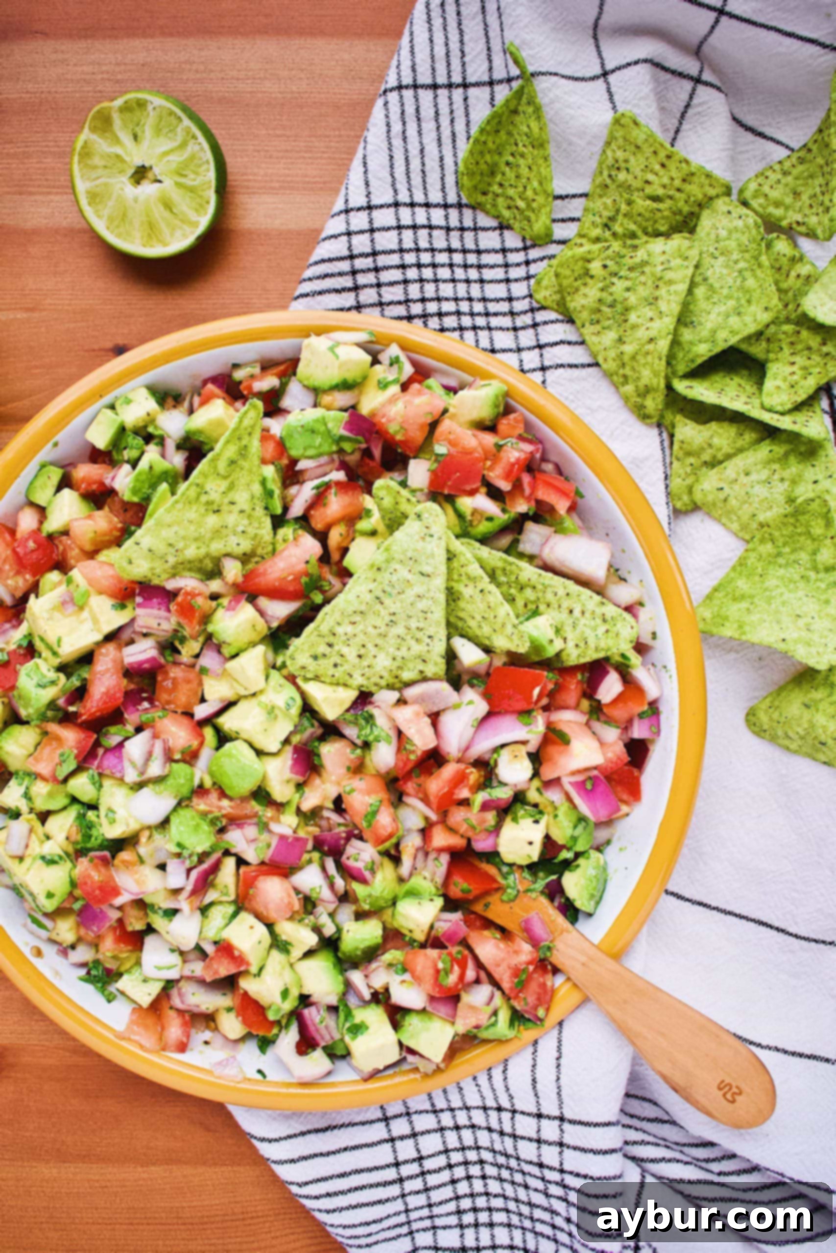 Close-up of freshly prepared Avocado Salsa, featuring chunks of avocado, tomato, and red onion, garnished with cilantro.