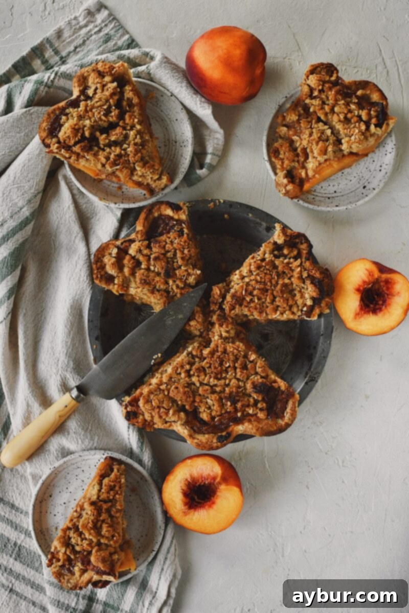 Warm Spiced Peach Crumble 8 Looking down at a sliced spiced peach pie, ready to be eaten.
