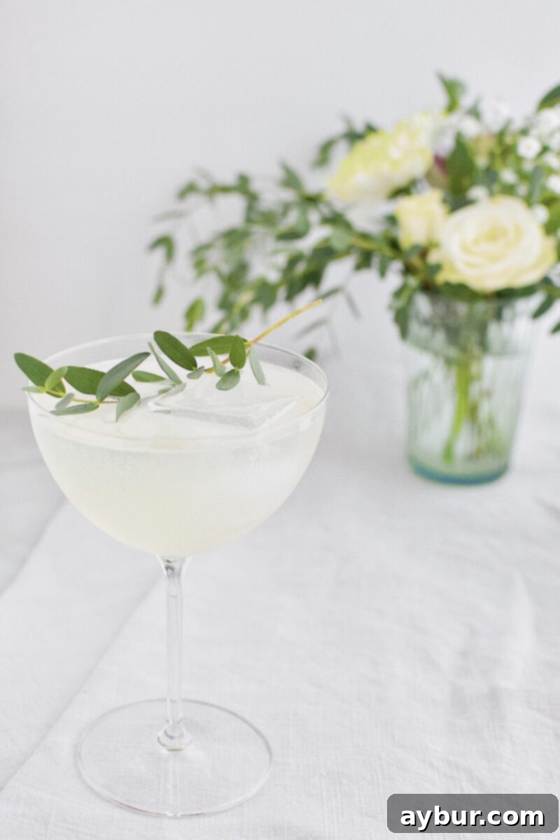 Sparkling Pear and Elderflower Lemonade cocktail recipe being poured into a glass