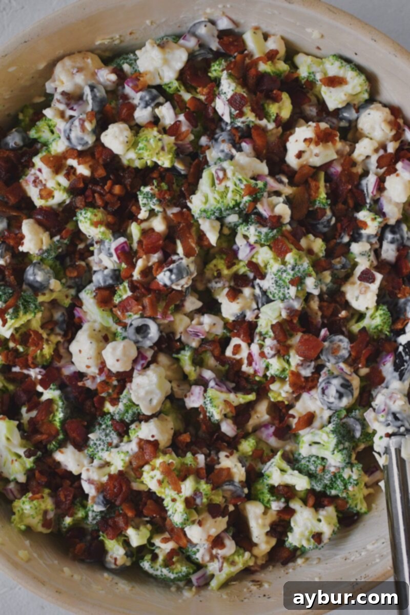 Vibrant Broccoli and Cauliflower Power Salad 8 Fully mixed salad topped with more bacon and ready to serve.