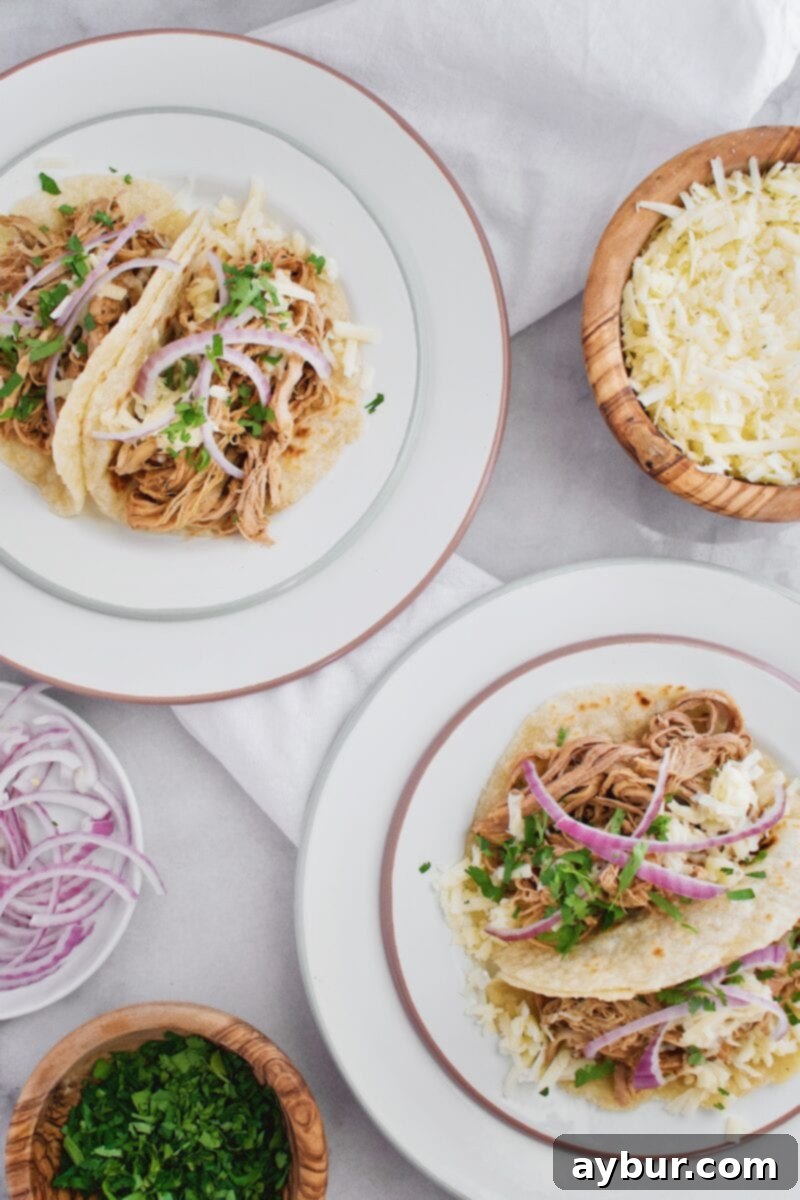 Joanna Gaines recipe for Pulled Pork Street Tacos - A vibrant collection of taco toppings including fresh cilantro, red onion, and lime wedges.