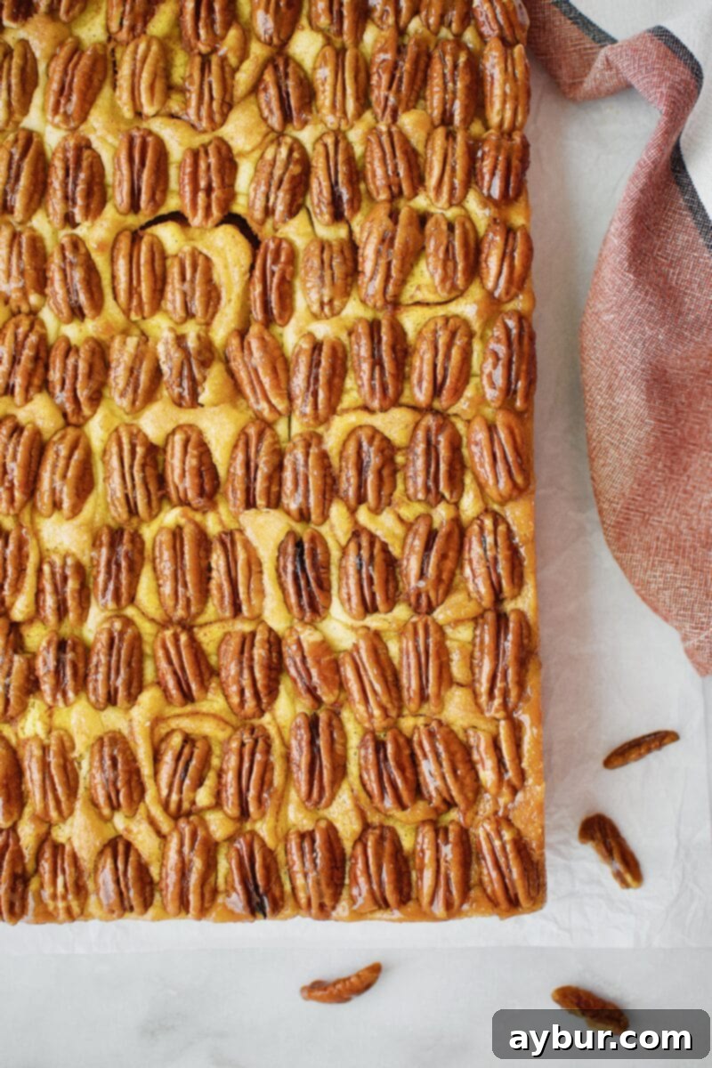 Freshly baked Pumpkin Spice Sticky Buns with pecans and a rich caramel glaze