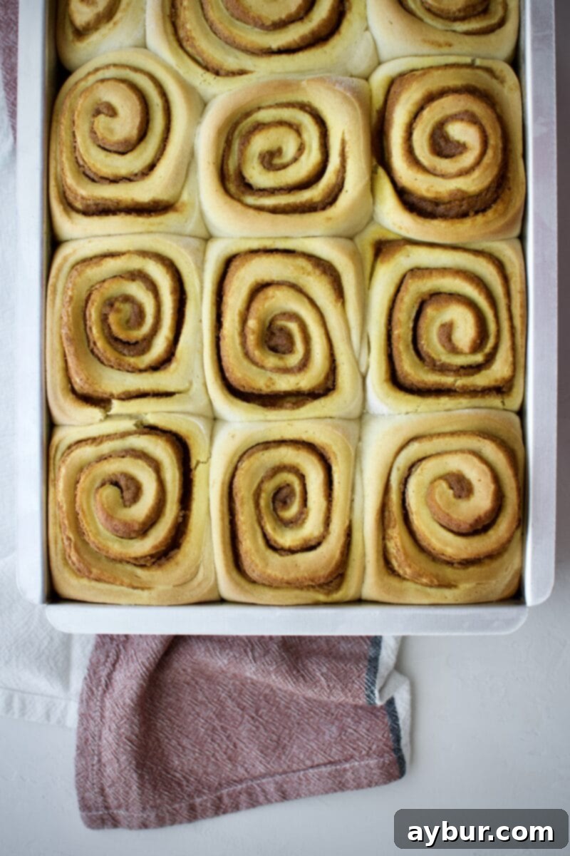 Golden brown Pumpkin Sticky Buns fresh out of the oven, bubbling with sticky topping