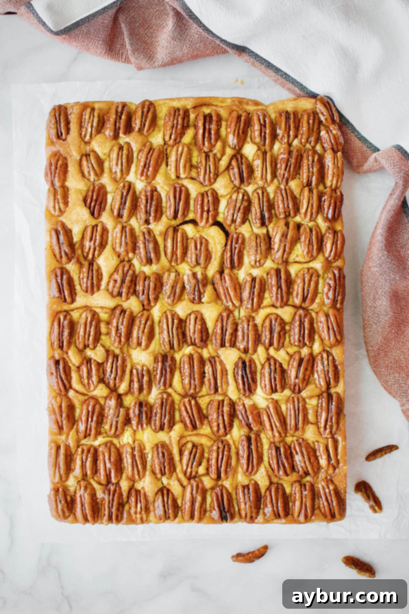 Glorious Pumpkin Pecan Praline Sticky Buns, freshly flipped and glistening with caramel