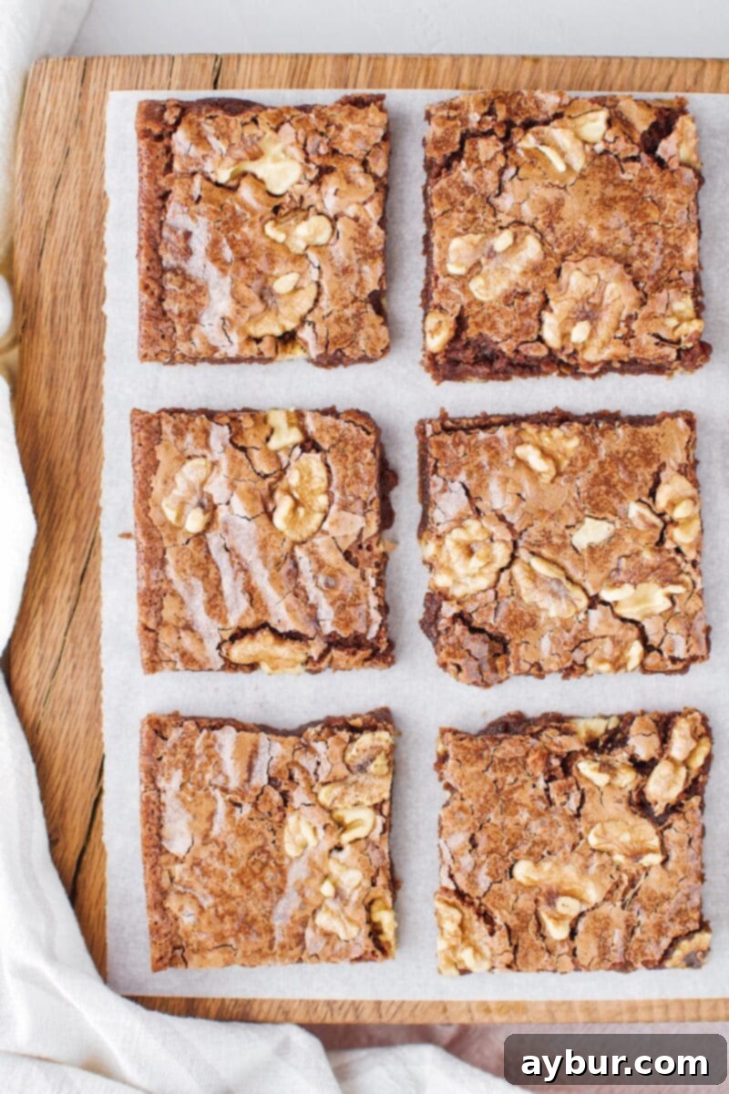 Decadent Fudgy Walnut Brownies 2 Classic Fudgy Walnut Brownies served on a white plate