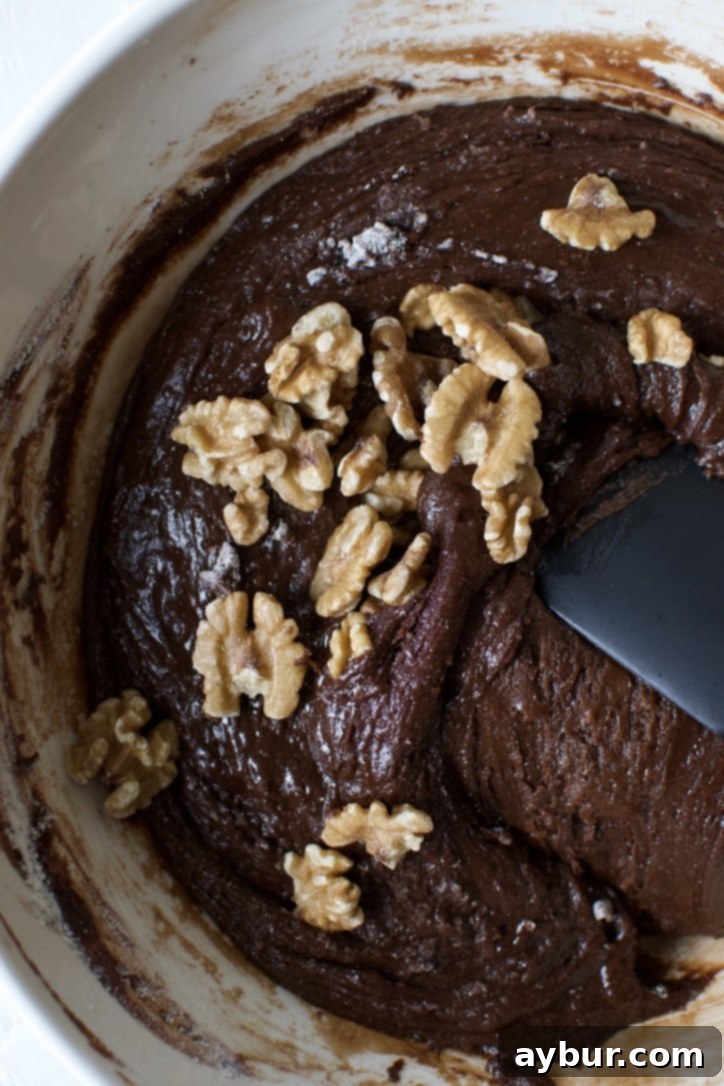 Decadent Fudgy Walnut Brownies 8 Folding chopped walnuts into the classic brownie batter with a spatula