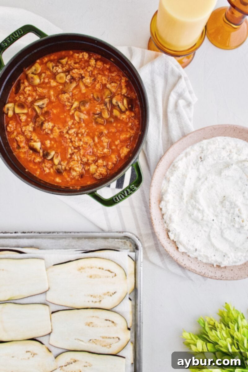 Prepared ingredients for Homemade Eggplant Parmesan Rollatini including sliced eggplant and seasoned ricotta