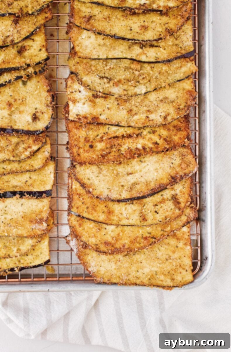 Golden brown fried eggplant slices ready for filling and rolling