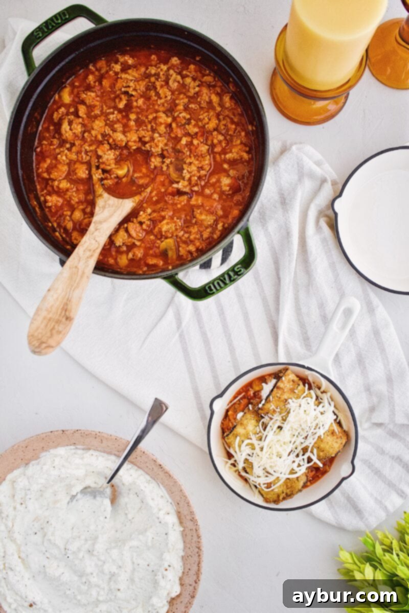 Eggplant rolls meticulously lined up in their baking pan, ready for the oven