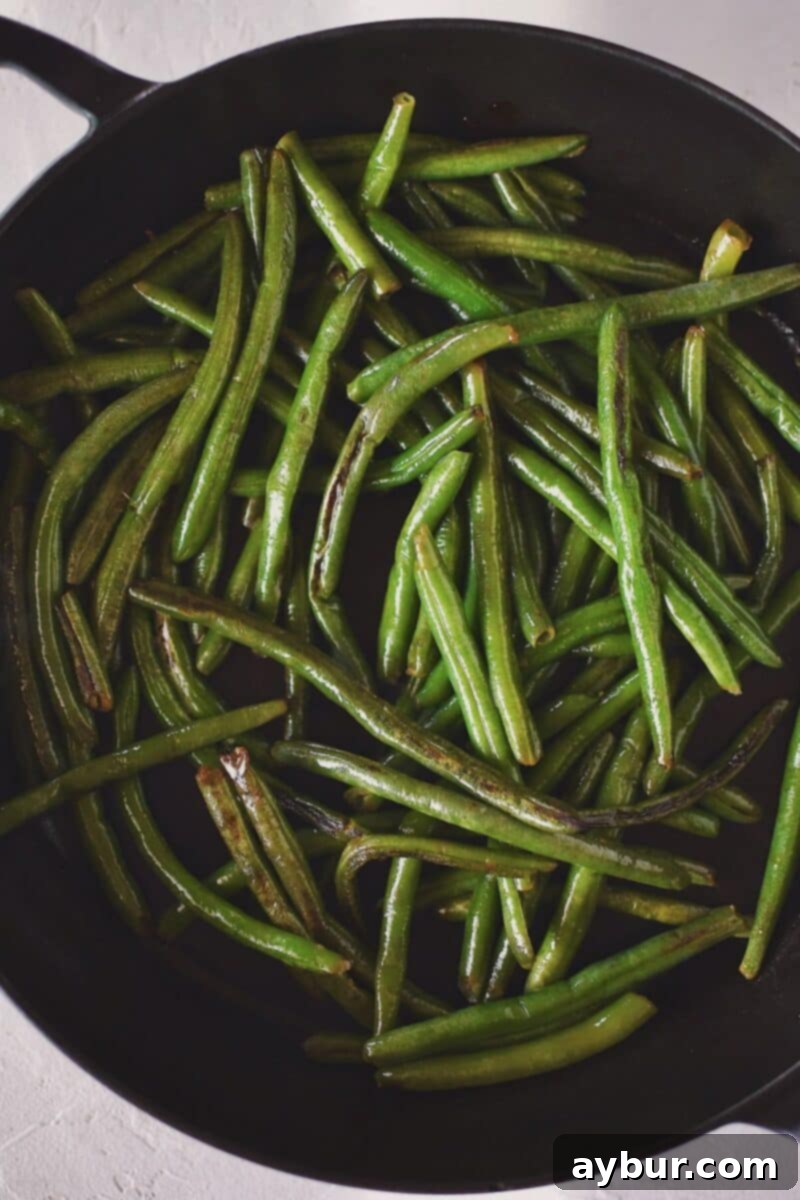 Vibrant Green Bean Salad 5 Cooking the green beans in olive oil, in a large skillet till they begin to brown and blister, enhancing their flavor.