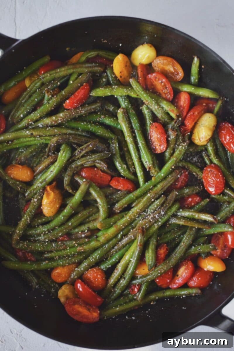 Vibrant Green Bean Salad 6 Adding the tomatoes to the pan, along with the soy sauce and vinegar, lemon juice, salt, and pepper, and cooking till the pan is nearly dry again, forming a flavorful glaze.