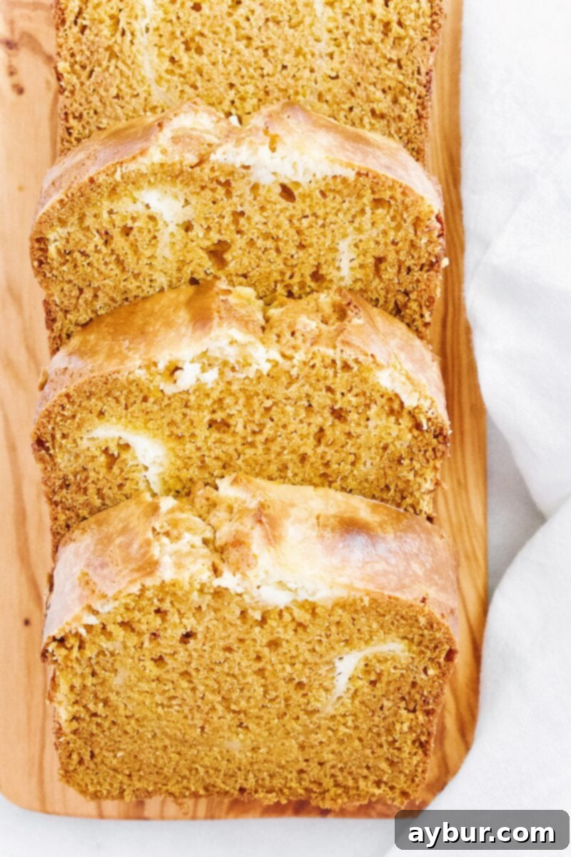 A close-up of the interior of Joanna Gaines' Pumpkin Cream Cheese Loaf, showing the beautiful cream cheese swirl.