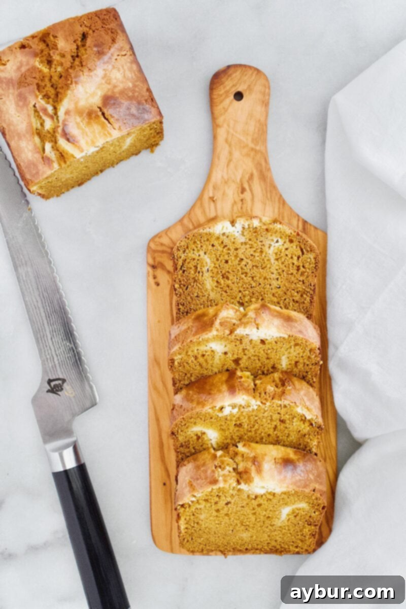 A slice of Joanna Gaines Pumpkin Cream Cheese Loaf served on a plate, ready to be enjoyed.