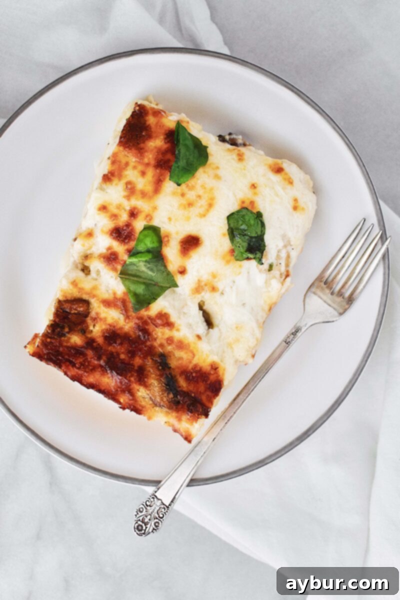 A perfectly baked slice of Joanna Gaines' White Vegetable Lasagna, showcasing its creamy layers and golden-brown top.