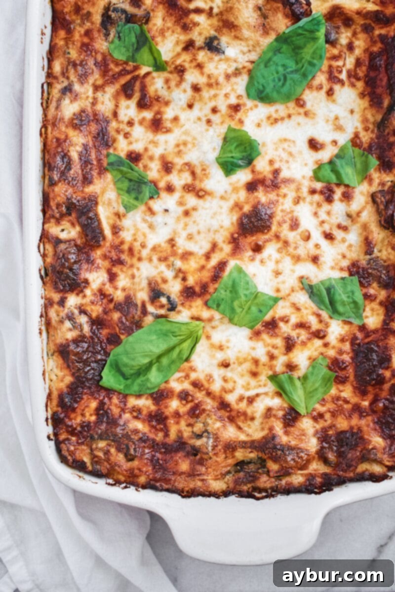 Close-up of the delicious mushroom and cheese filling within Joanna Gaines' White Vegetable Lasagna, ready for baking.
