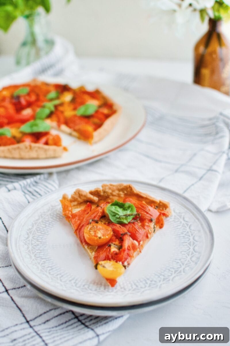Rustic Roasted Tomato Tart 11 Two large slices of Roasted Tomato Tart on a rustic wooden board, garnished with fresh basil