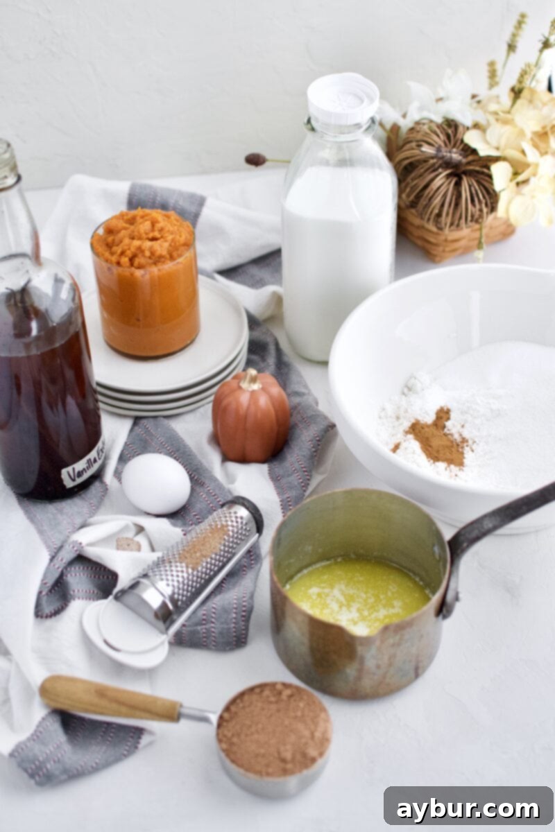 Wet ingredients for pumpkin bread, including pumpkin puree, butter, egg, milk, and vanilla, blended until smooth