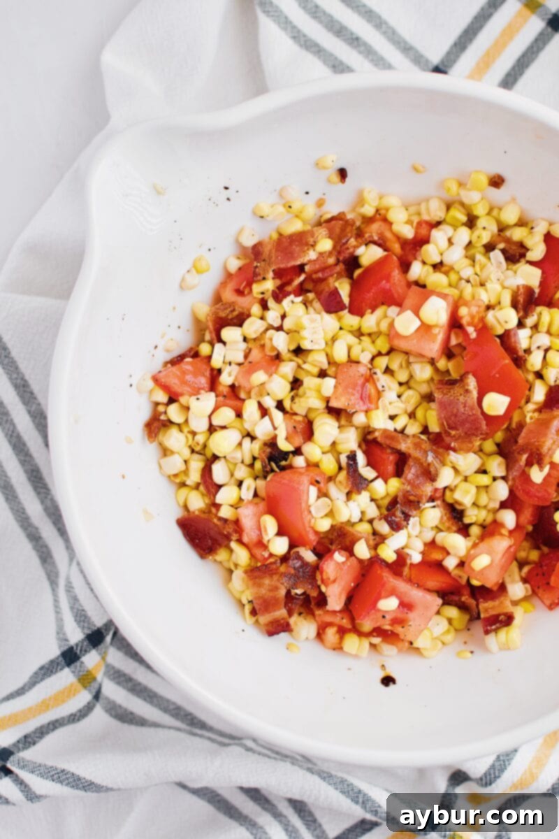 A fresh and vibrant corn, tomato, and bacon salad, ready to top the smashed potatoes