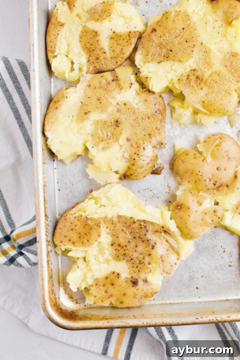 Boiled potatoes that have been perfectly smashed and are ready for the broiler
