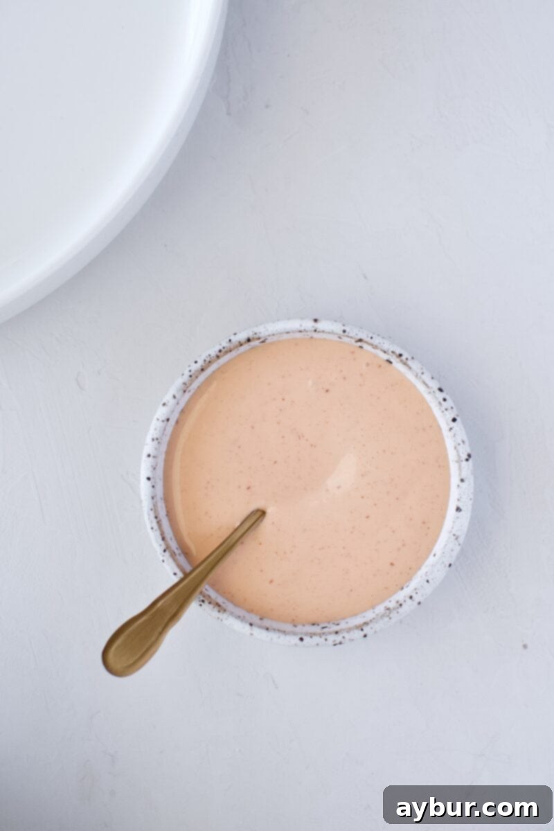 Bowl of freshly made spicy mayonnaise, a perfect sushi condiment, ready for use in the Ahi Tuna Tower recipe.