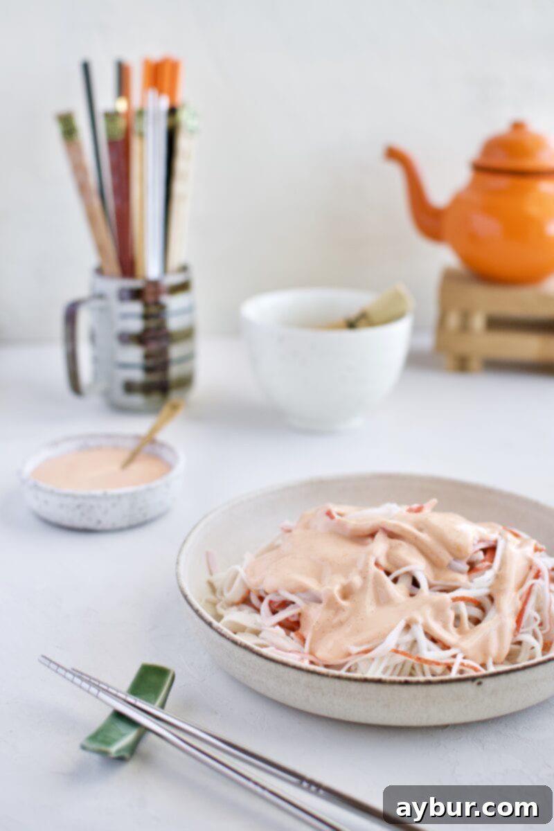 Shredded crab sticks with a dollop of spicy mayo on top, ready to be mixed for the Ahi Tuna Tower recipe.