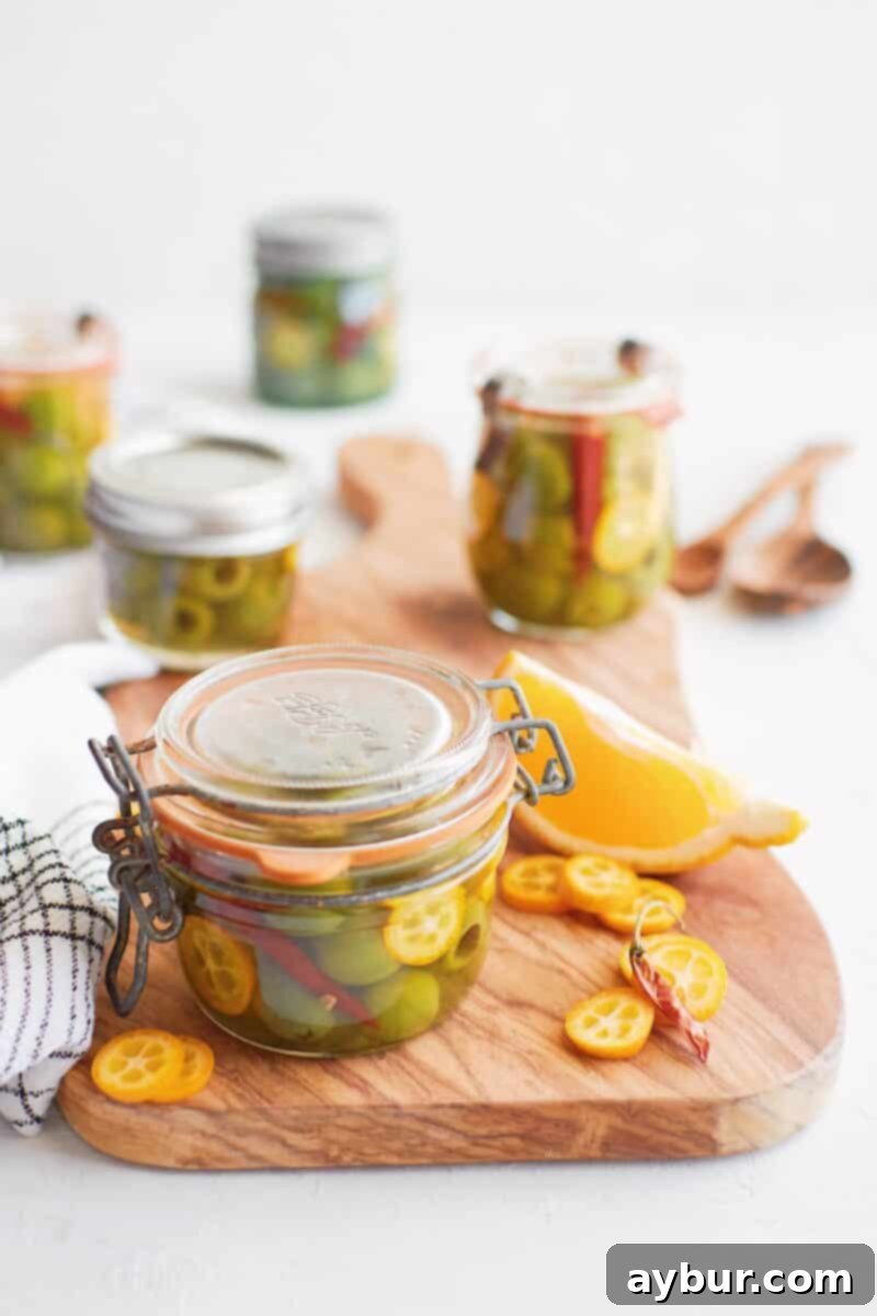 Spicy Citrus Marinated Olives 5 Close-up of finished marinated olives with kumquats and chili in a glass jar