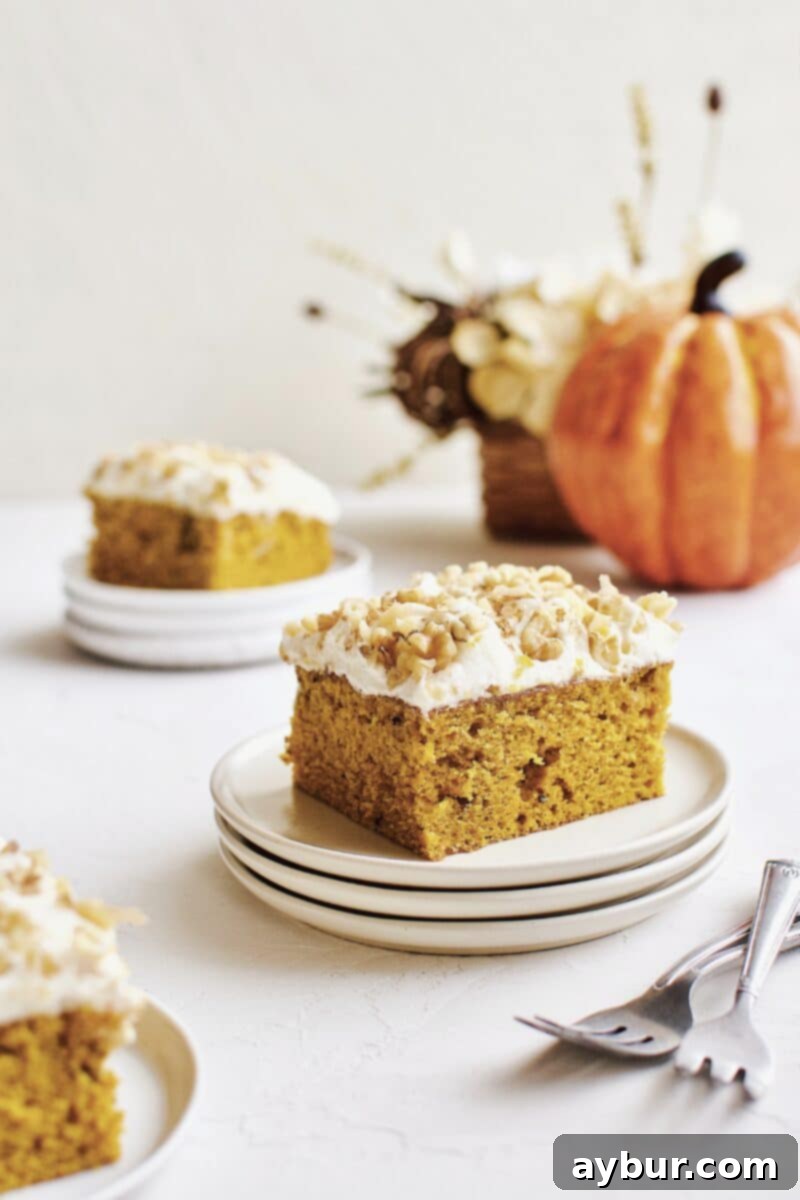 Spiced Pumpkin Walnut Cake with Creamy Cream Cheese Frosting 2 Pumpkin Cake sliced and ready to serve, showcasing the moist interior and fluffy frosting