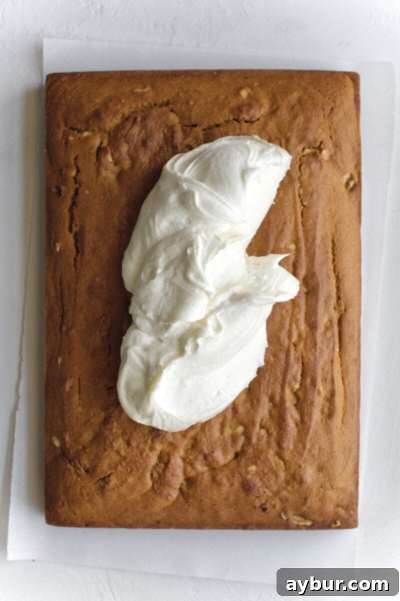 Spiced Pumpkin Walnut Cake with Creamy Cream Cheese Frosting 9 All the cream cheese frosting generously scooped onto the center of the cooled pumpkin cake