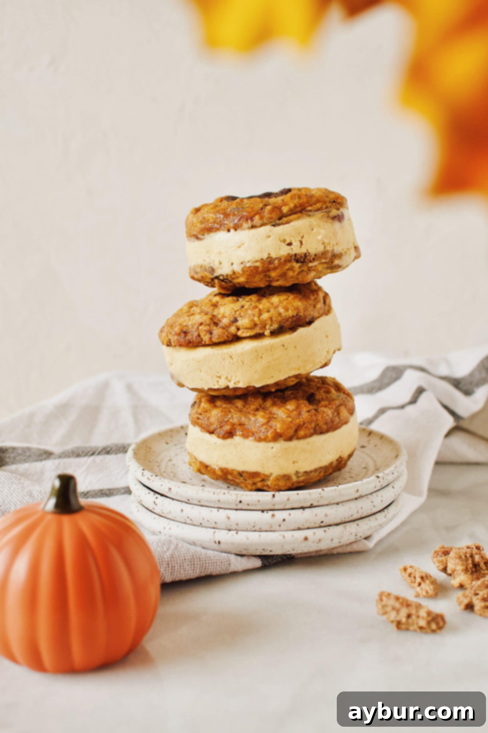 Homemade ice cream sandwiches made with Pumpkin Oatmeal Cookies and a creamy pumpkin cardamom ice cream filling.