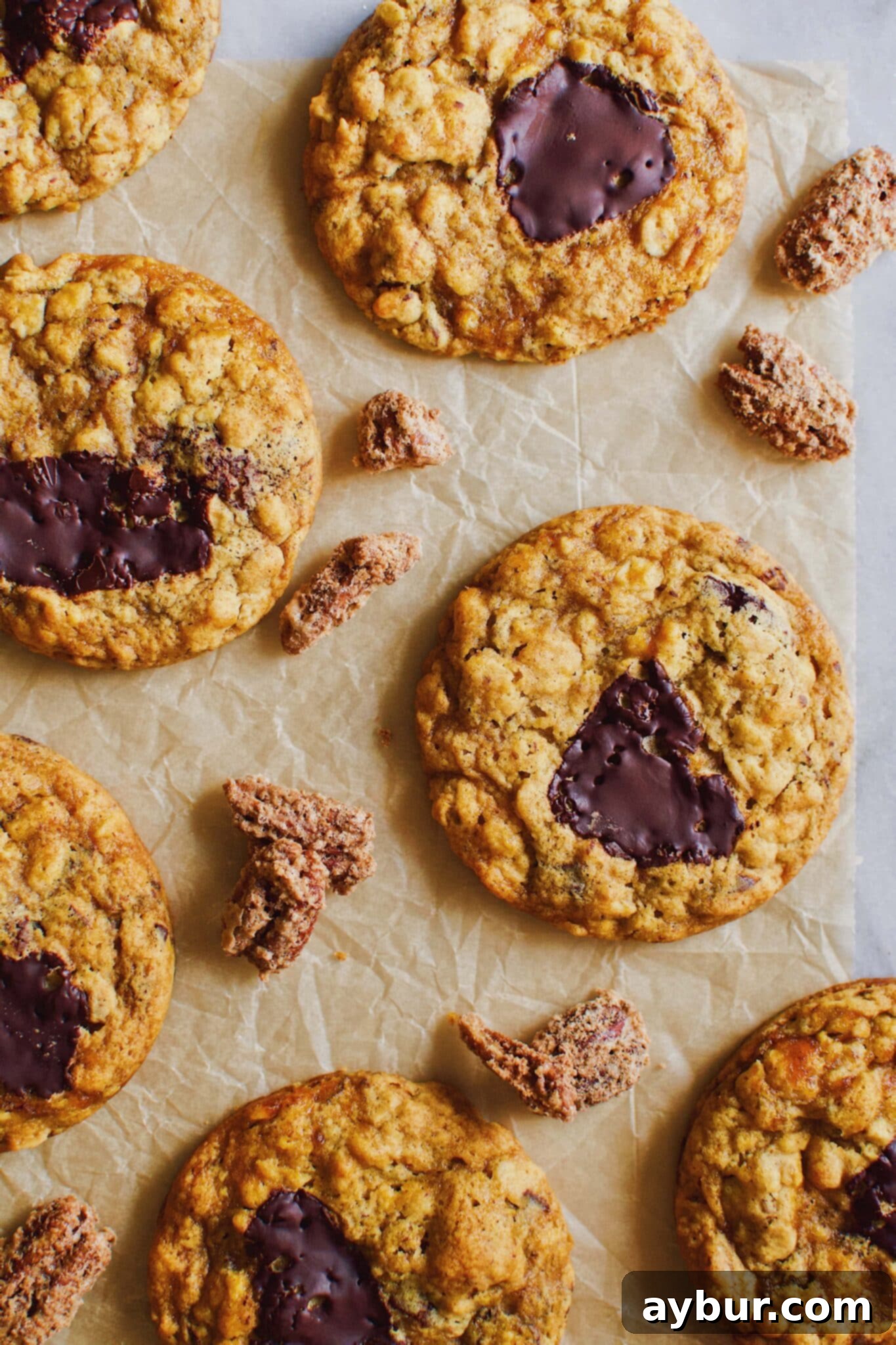 Freshly baked Pumpkin Chocolate Chunk Oatmeal Cookies on a cooling rack, glistening with melted chocolate.